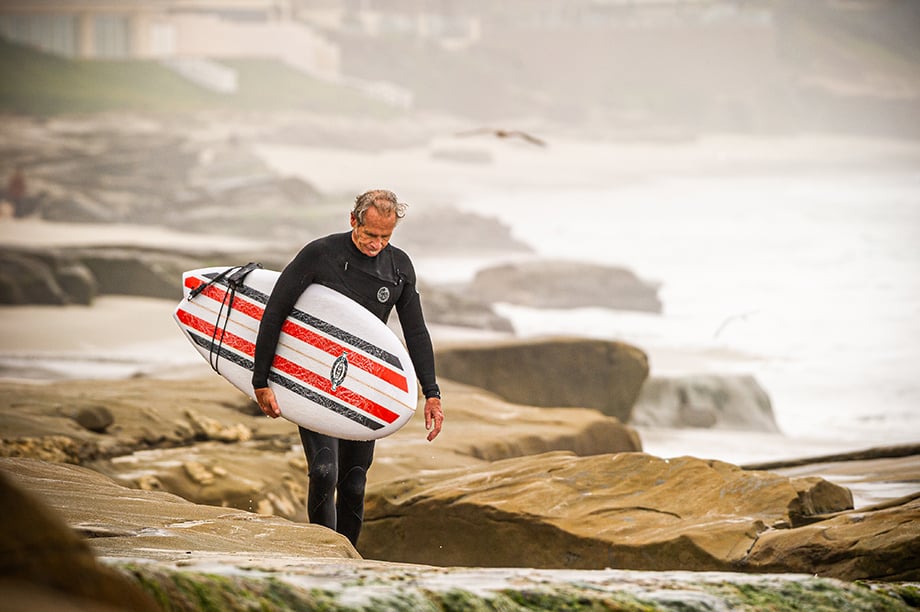 Tim Bessell with a custom surfboard, photographed by Aaron Ingrao. 