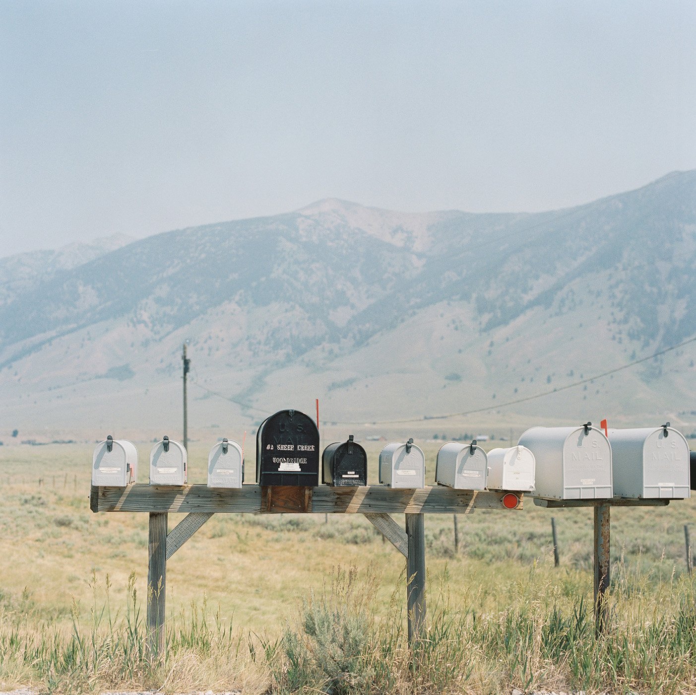 Mailboxes in a row in front of a mountain view landscape shot by Abigail Bobo for First Opportunity bank