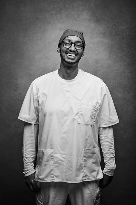 Smiling portrait of Nurse Dawit Woldegebriel photographed by Angelo Merendino. 