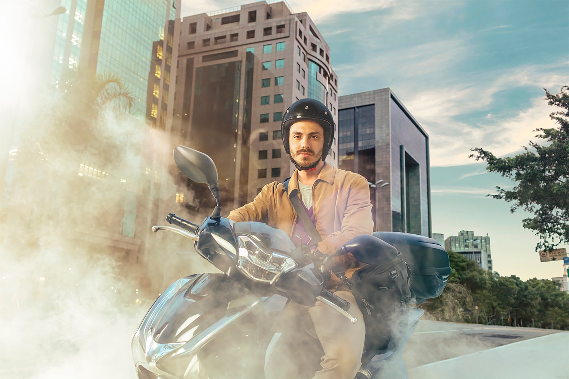 Portrait of a man riding motorcycle with dust around him shot by Claus Lehmann for Allegra campaign