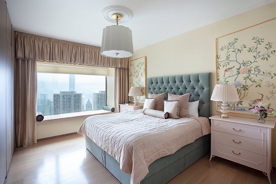 Denice Hough photographs a serene bedroom in light hues and comfortable fabrics overlooks the cityscape. 
