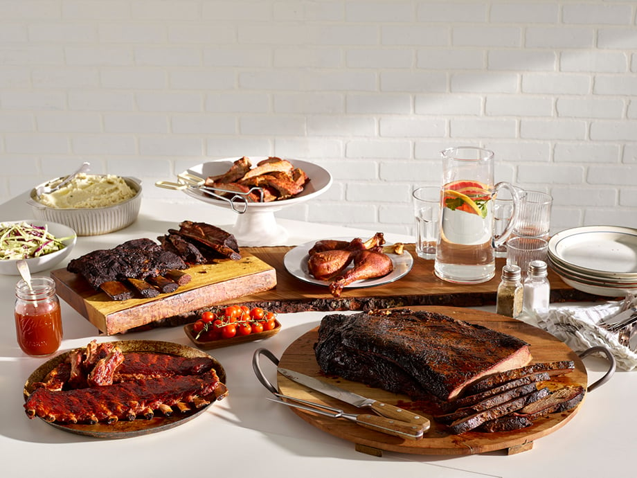 A spread of several barbecue dishes. Photography by Dhanraj Emanuel for Keto BBQ. 
