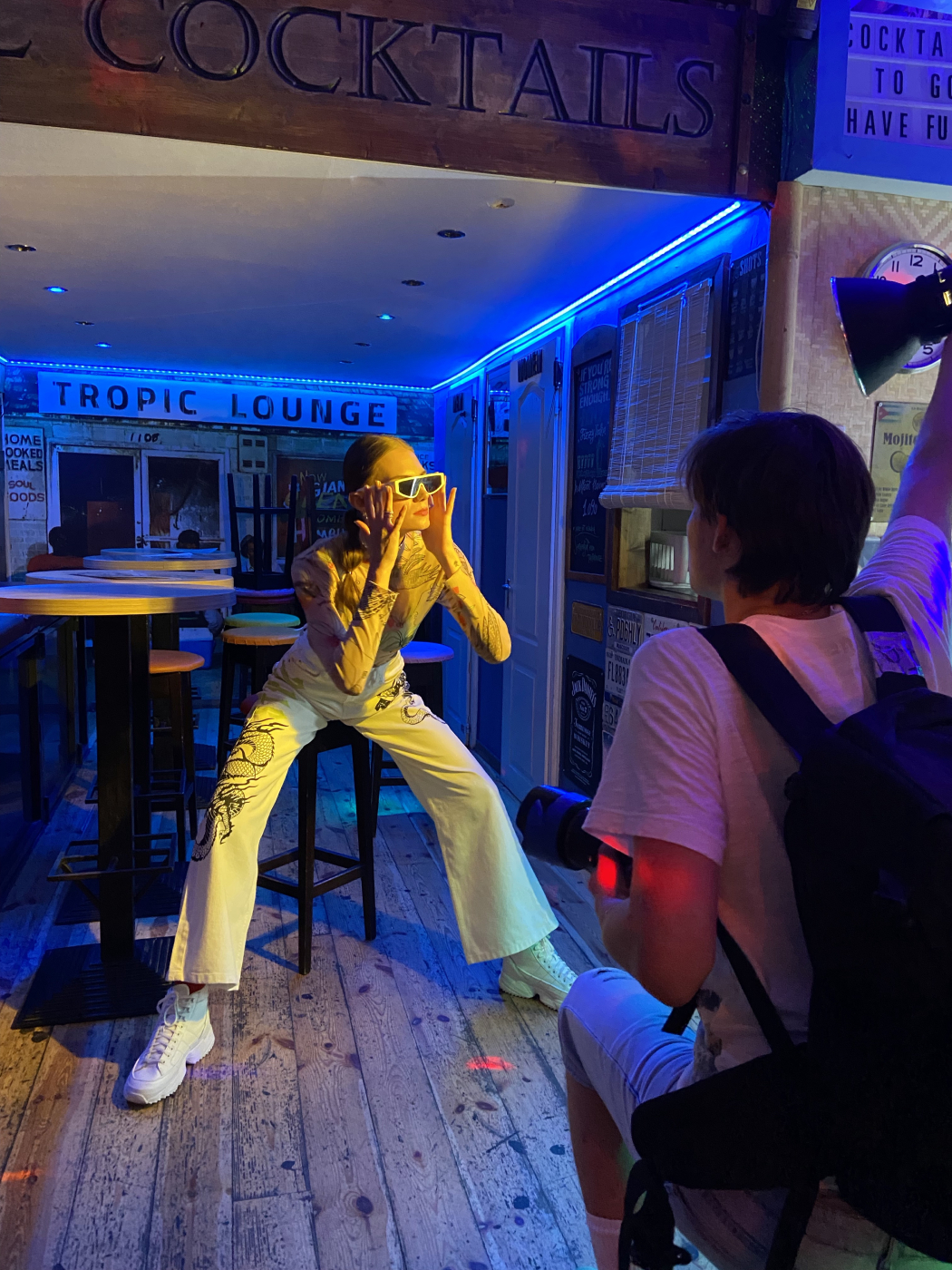 Behind the scenes shot of model Reka Fedra in blue light bar shot by Illya Ovchar for Glamour Hungary
