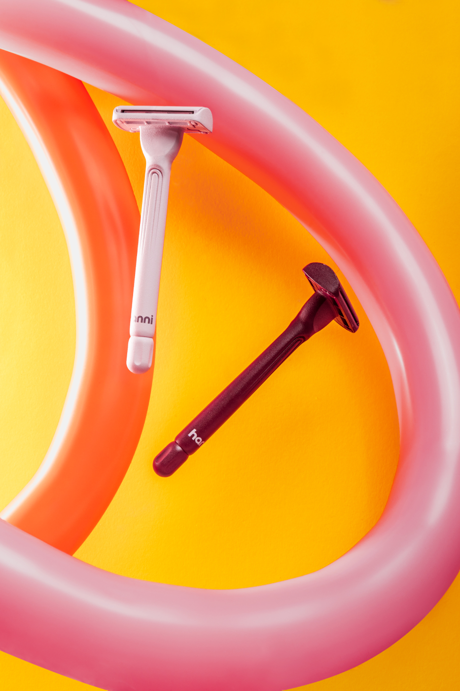Two Hanni razors shaving long the curve of an animal balloon shot by Katelin Kinney