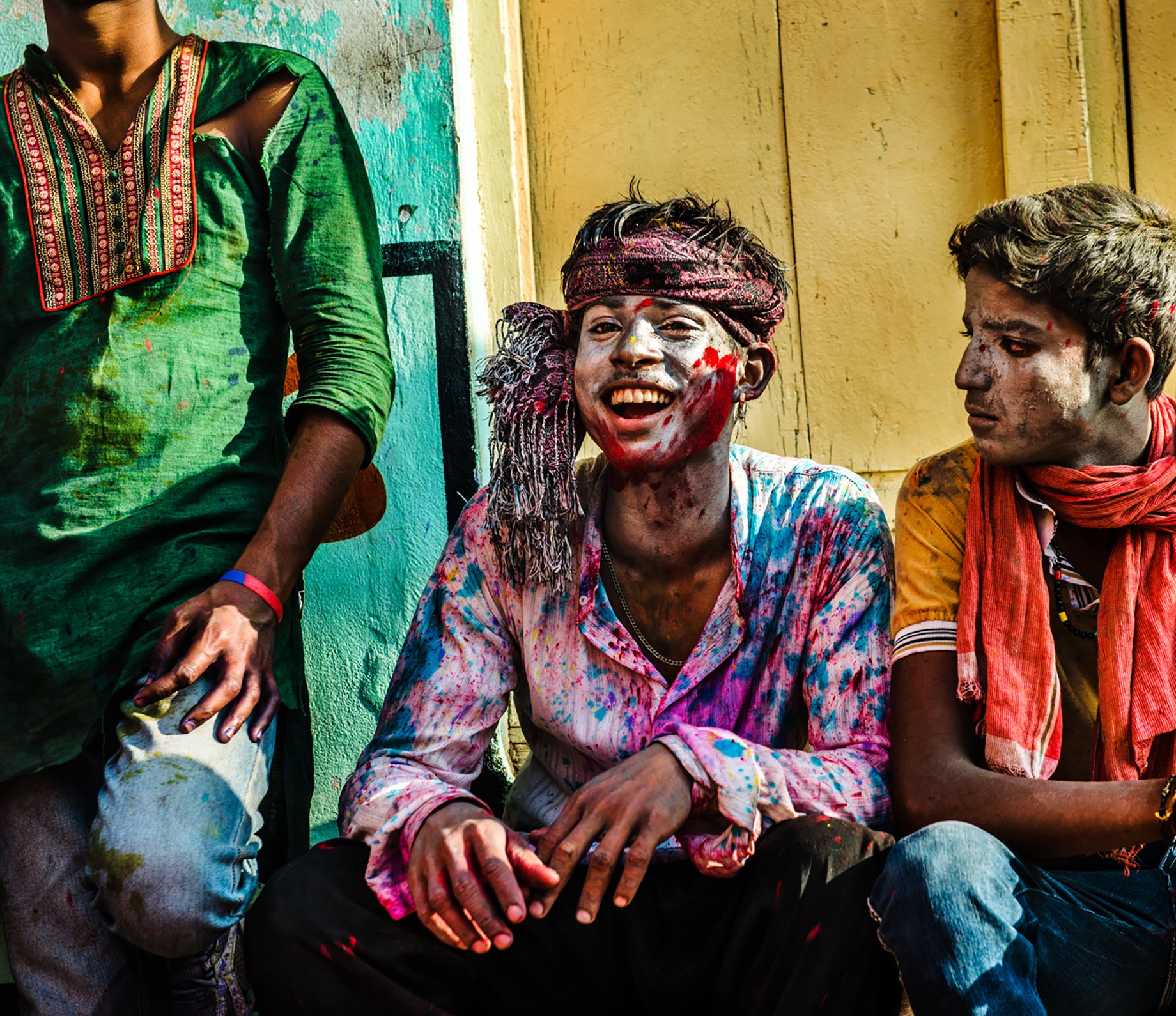 Three men in left over paint from Holi festival shot by Michael Marquand for Lodestars Anthology.