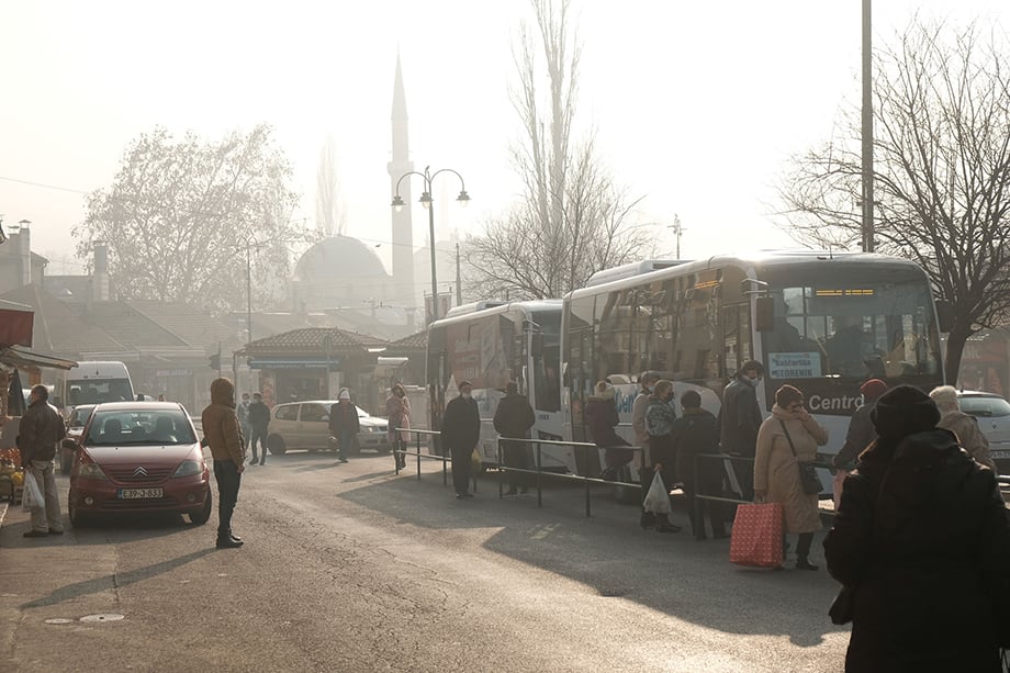 Sarajevans wait at a bus stop on a day when Sarajevo ranked among the most polluted cities in the world with an AQI rating of over 300. Photography by Nick St. Oegger. 