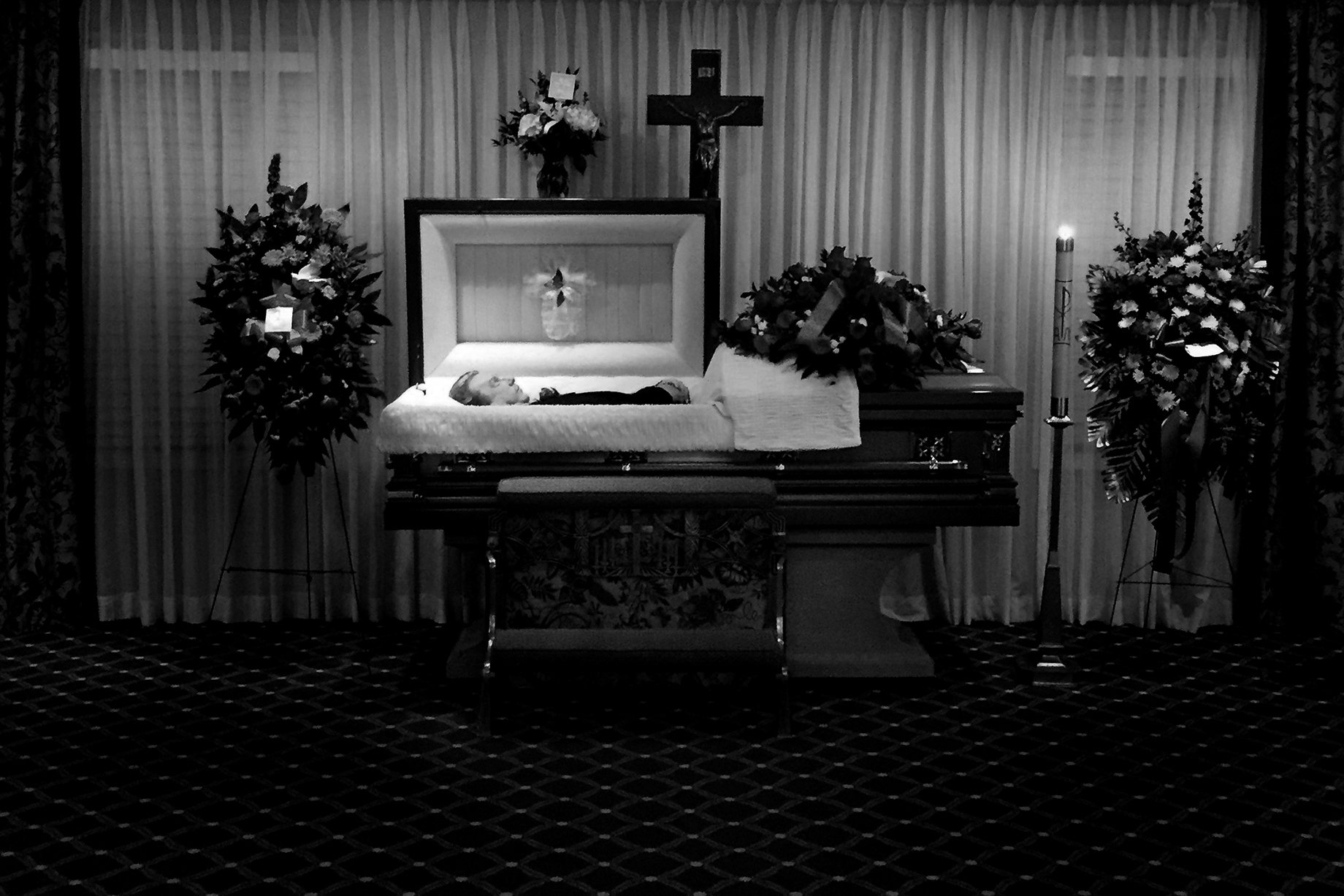 Photographer Sean Scheidt's grandfather in his casket in black and white