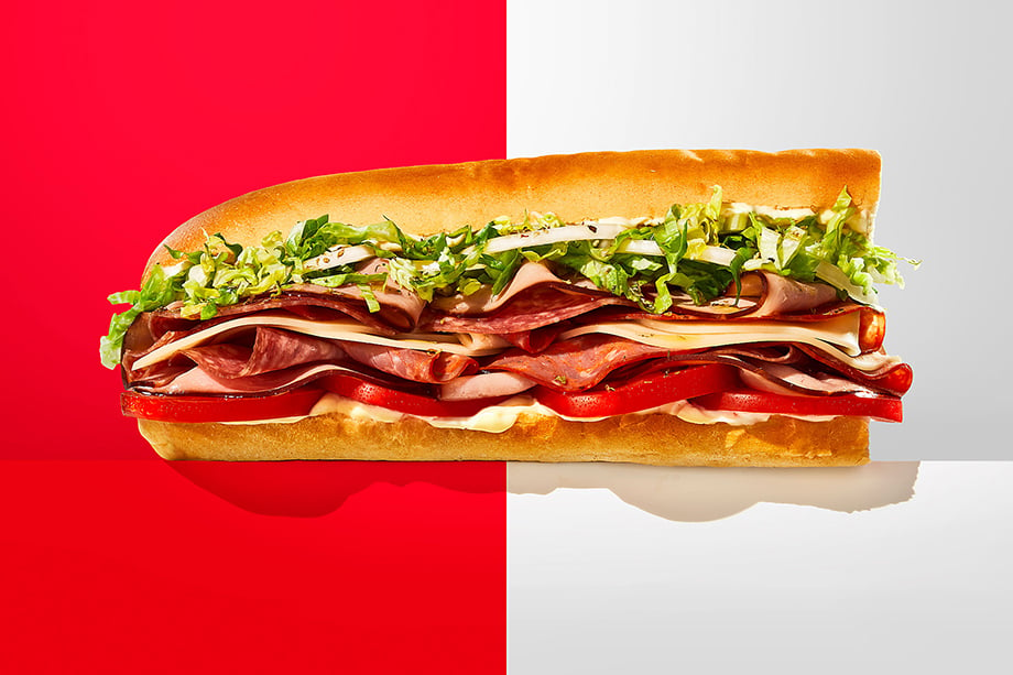 A Jimmy John's sub photographed against a red and white backdrop. Photography by Teri Studios. 