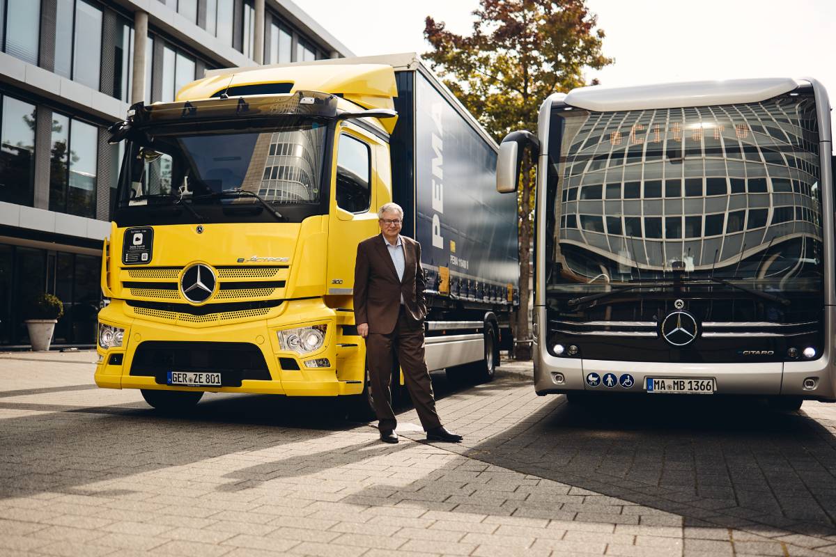 Photo by Michael Schulz Daimler Truck CEO Martin Daum between a massive electric truck and electric bus.