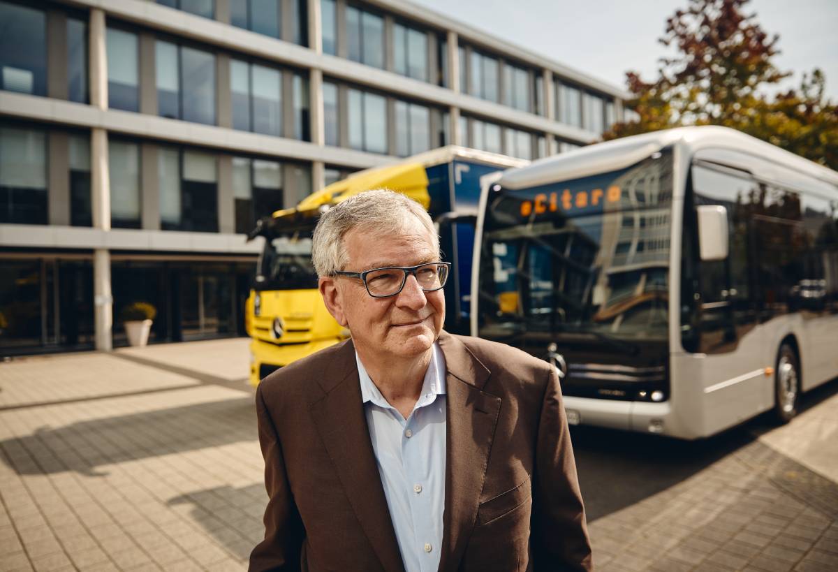 Photo by Michael Schulz of Daimler Truck CEO Martin Daum standing in front of an electric truck and bus.