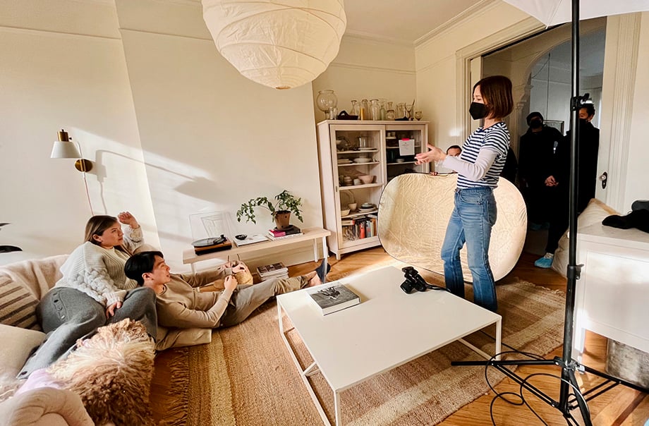 Emily Andrews directing talent during a living room scene at a home in Brooklyn for Con Edison photoshoot with producer Bryan Sheffield.