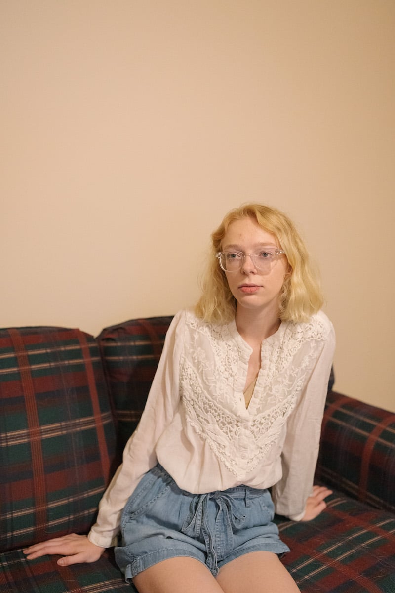 Keeley Bahn, 24, sits for a portrait in her apartment
