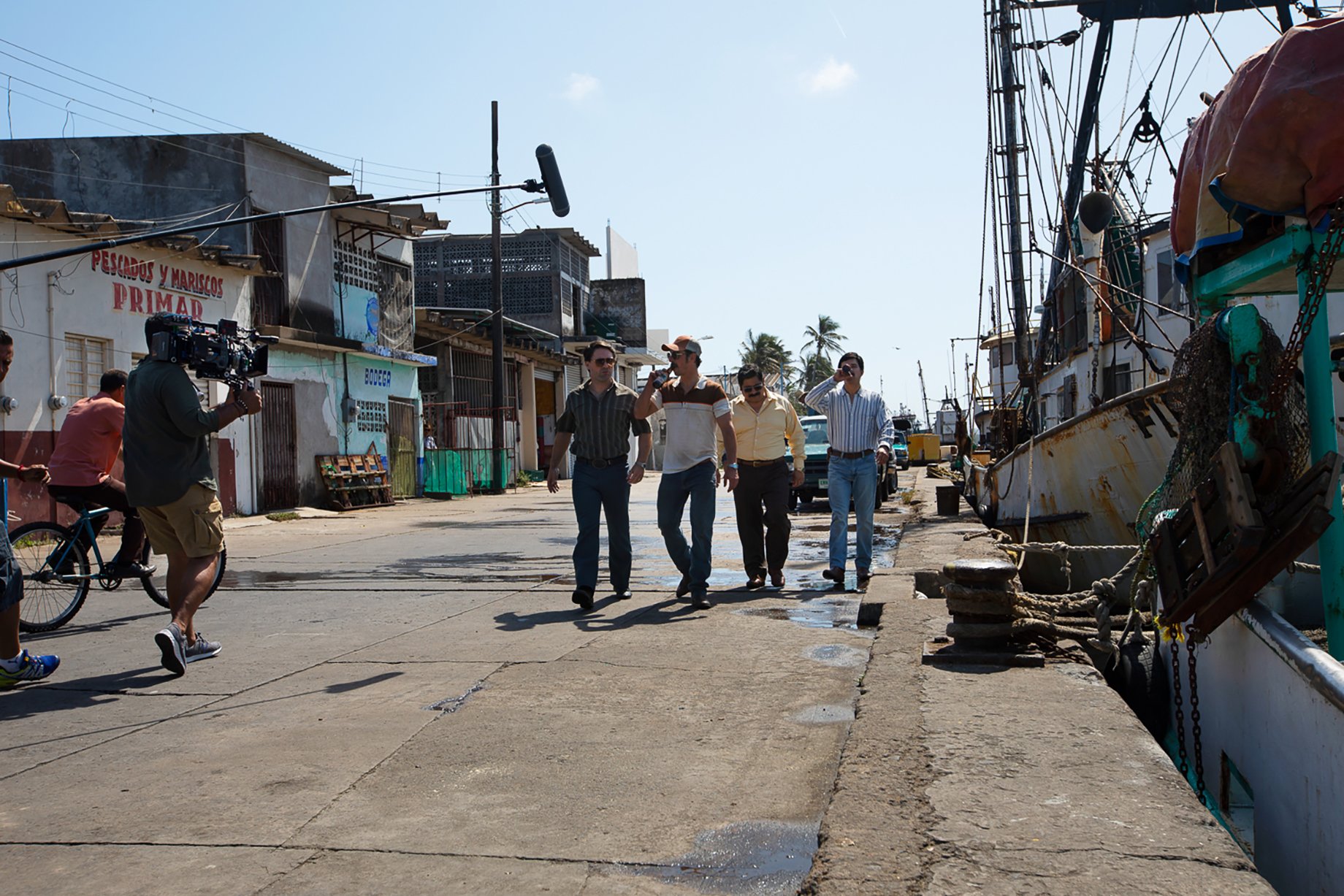 Behind-the-scenes shot of Tijuana cartels walking down pier shot in Veracruz, Mexico for Narcos: Mexico Season 3 shot by Nicole Franco for Netflix