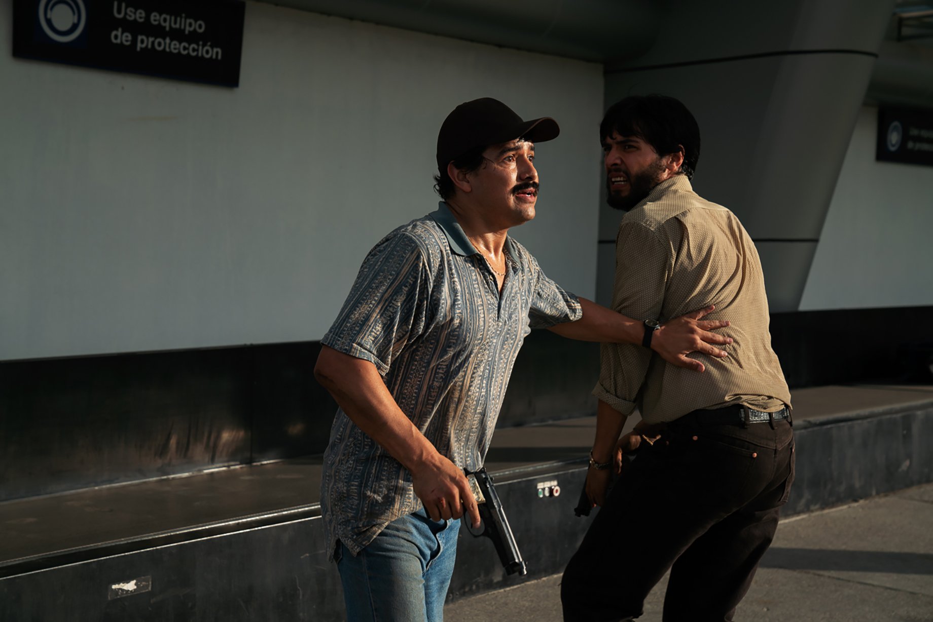 Two men run through airport for Narcos: Mexico season 3 shot by Nicole Franco for Netflix