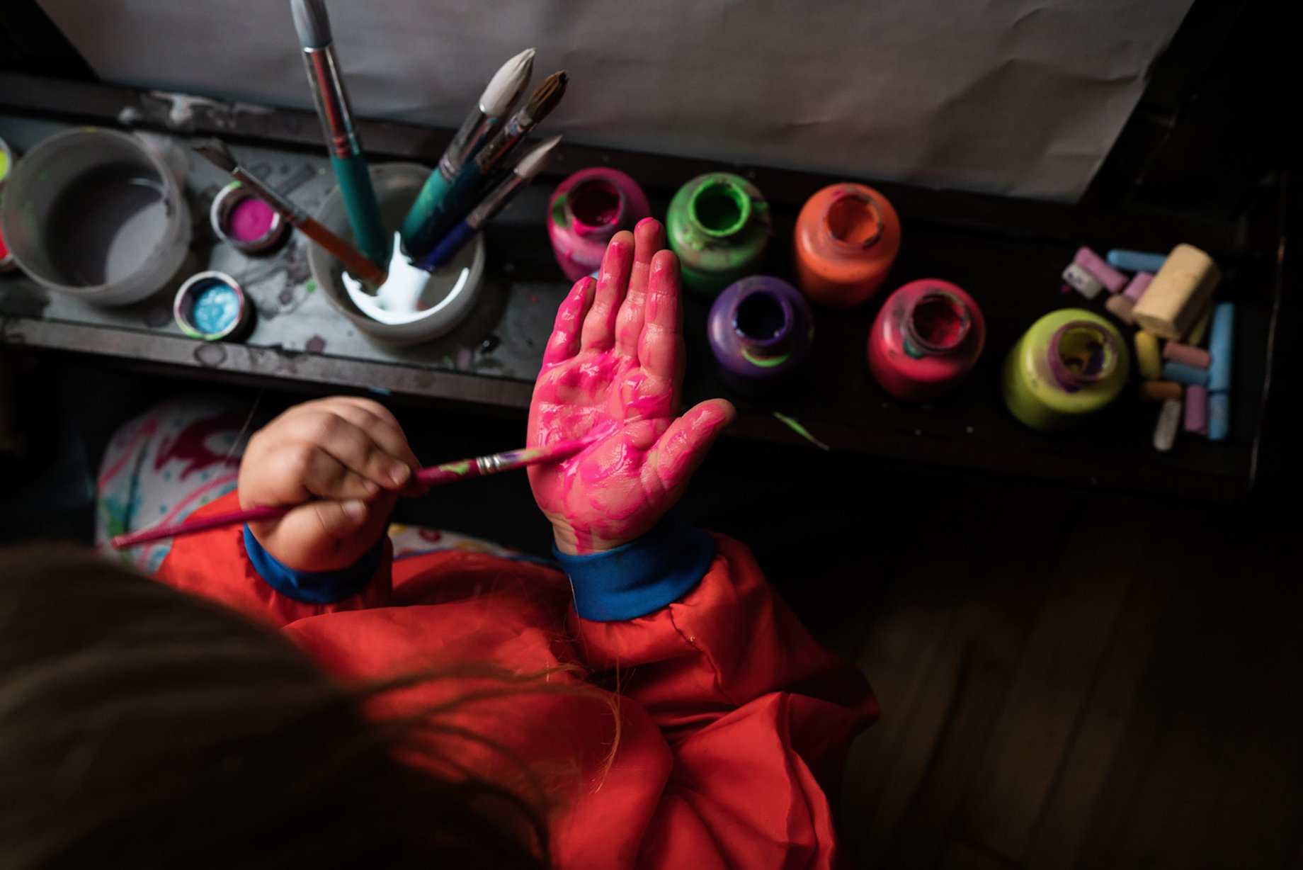 Photo of child painting shot by Kat Schleicher