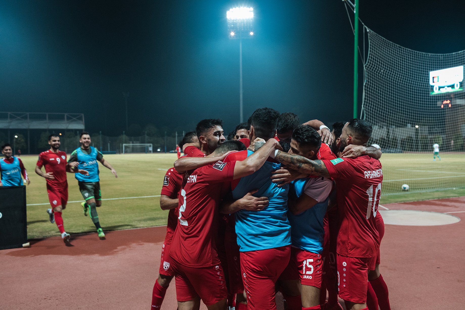 The Afghan national team celebrate a 1-0 victory against Indonesia in the team's first match since the Taliban took control of Afghanistan. Shot by Bradley Secker for the New York Times.