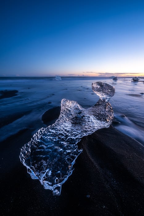 An image of a large piece of glacial ice found on the black sand beaches of Iceland, photographed by California-based Rachid Dahnoun.