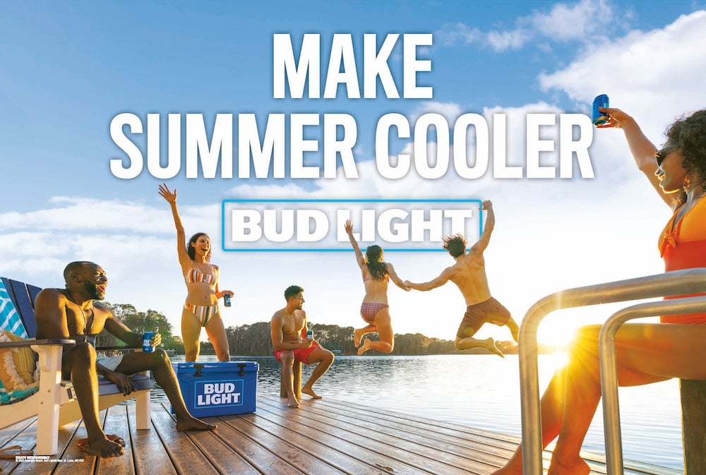 Photo with campaign name brand text of six friends at lake in swimwear with Bud Light beers, by Atlanta, Georgia-based brand narrative photographer Fernando Decillis.