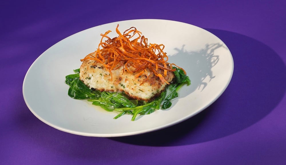Photo of pan-seared herbed white fish on bed of sautéed greens, with frizzled sweet potato garnish, by Seal Beach, California-based food/drink and music/performing arts photographer Eric Hameister. 