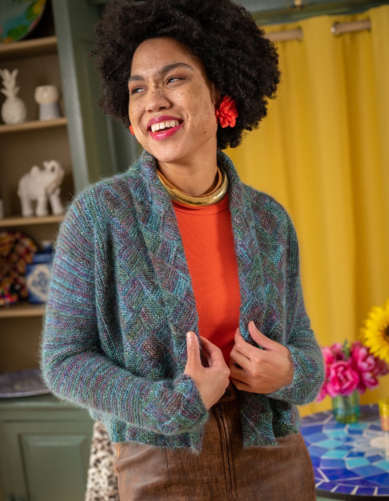 Photo of talent in hand-knit cardigan smiling in front of colorful background, by Branford, Connecticut-based fashion photographer Gale Zucker. 