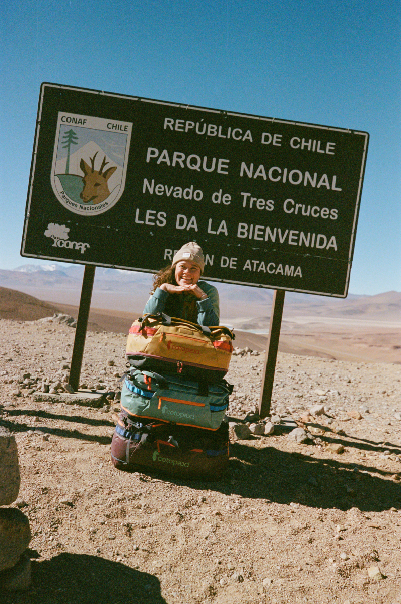 A color photo by Adam Wells of a model with Cotopaxi bags.