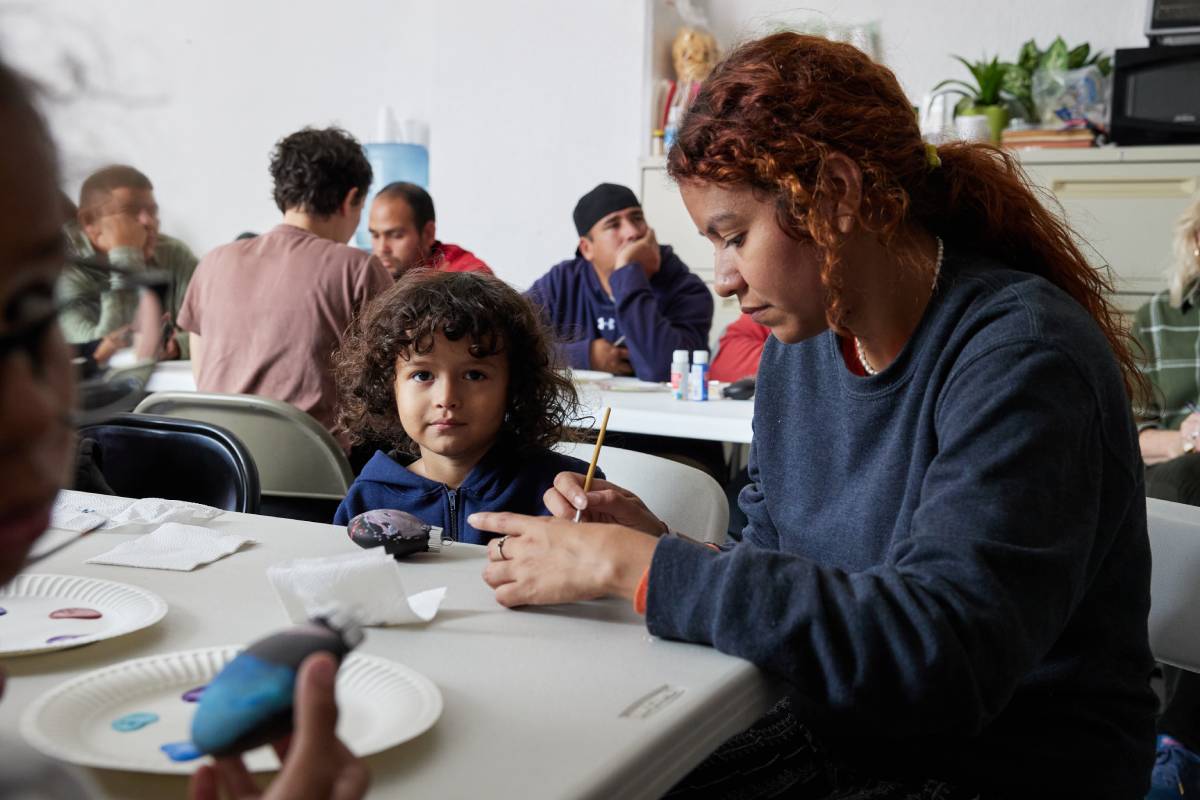 Photo of woman and her child doing art activities in the day shelter.