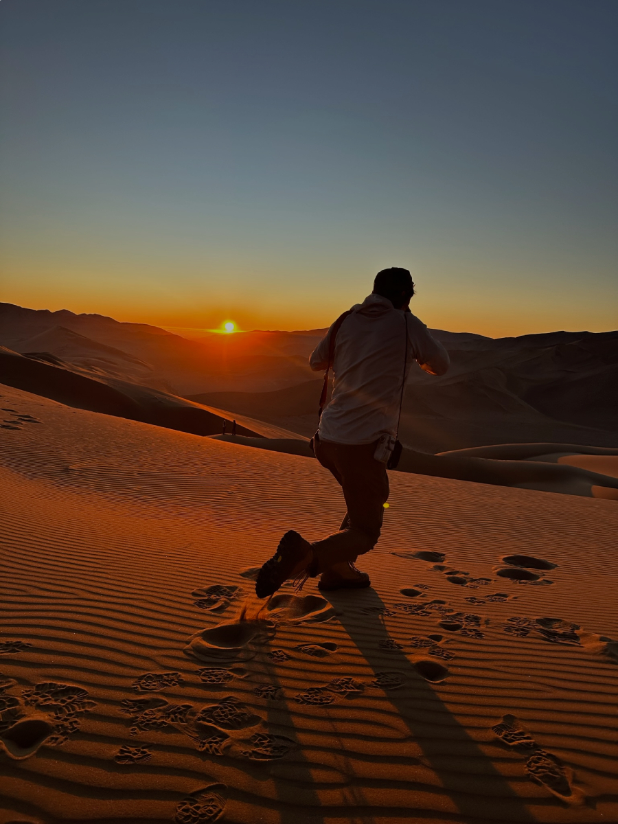A behind the scenes image of Adam Wells shooting in the desert.