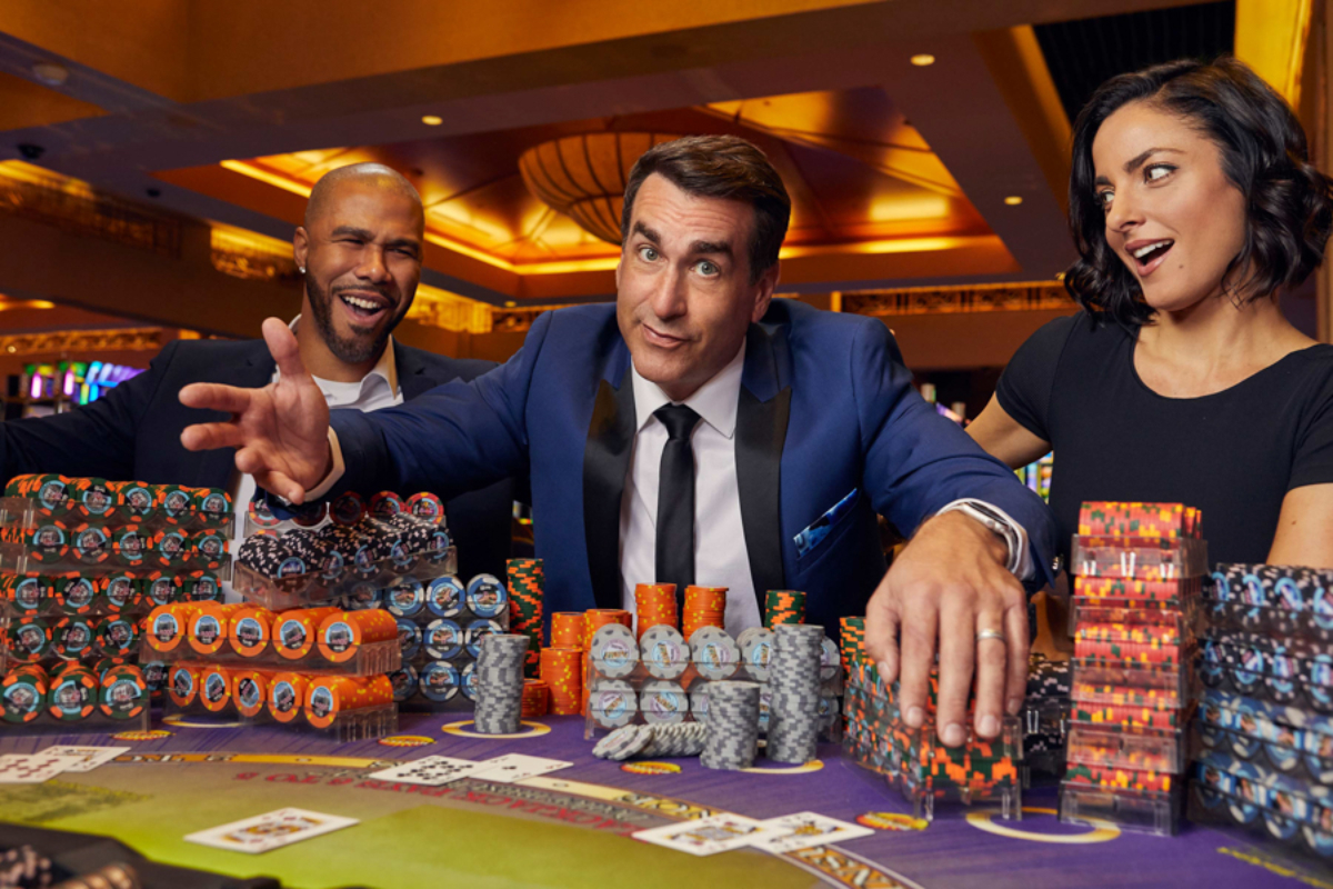 Rob Riggle strikes a charismatic pose, exuding confidence and a hint of playfulness, as he engages in a game of poker, photo by Los Angeles celebrity photographer duo JSquared.