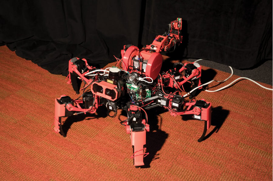 Photo of a six-legged red robot by Somerville, Massachusetts-based Ken Richardson.