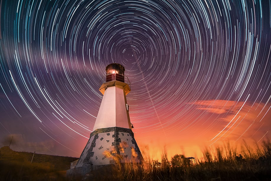 Night lighthouse by by Yevhen Samuchenko