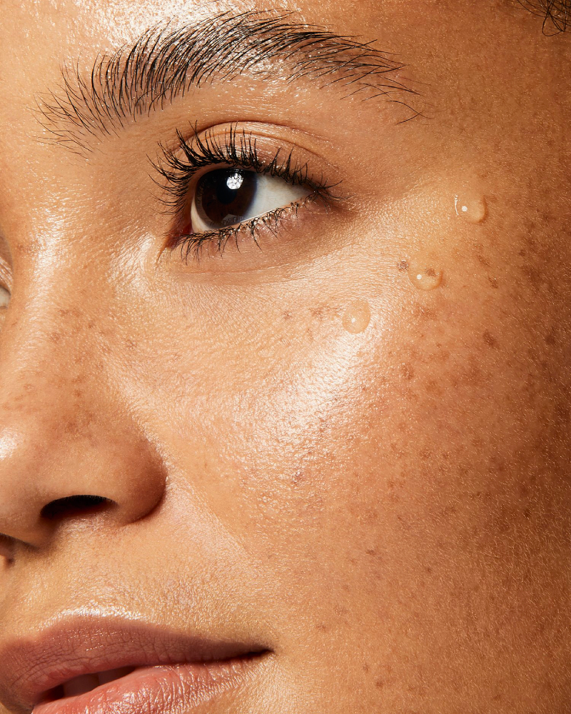 Photo by Adrianna Favero of a closeup on a model's face, highlighting healthy skin products.
