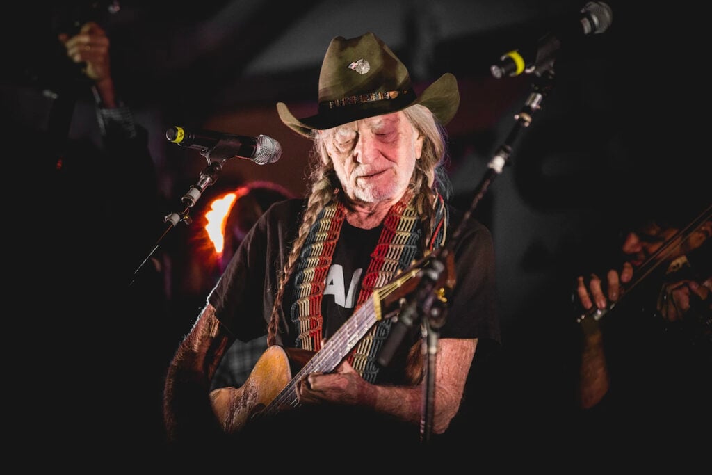 American singer and guitarist Willie Nelson performing, photographed by Andrew Bennett.