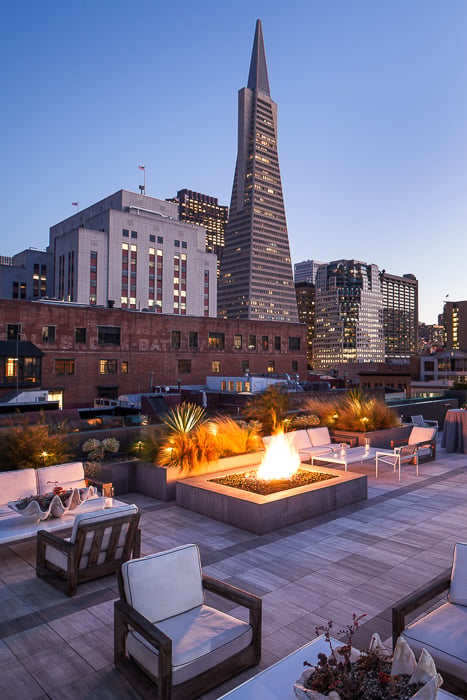 photo of a rooftop lounge overlooking skyscrapers taken by San Francisco-based architecture photographer Anthony Lindsey.