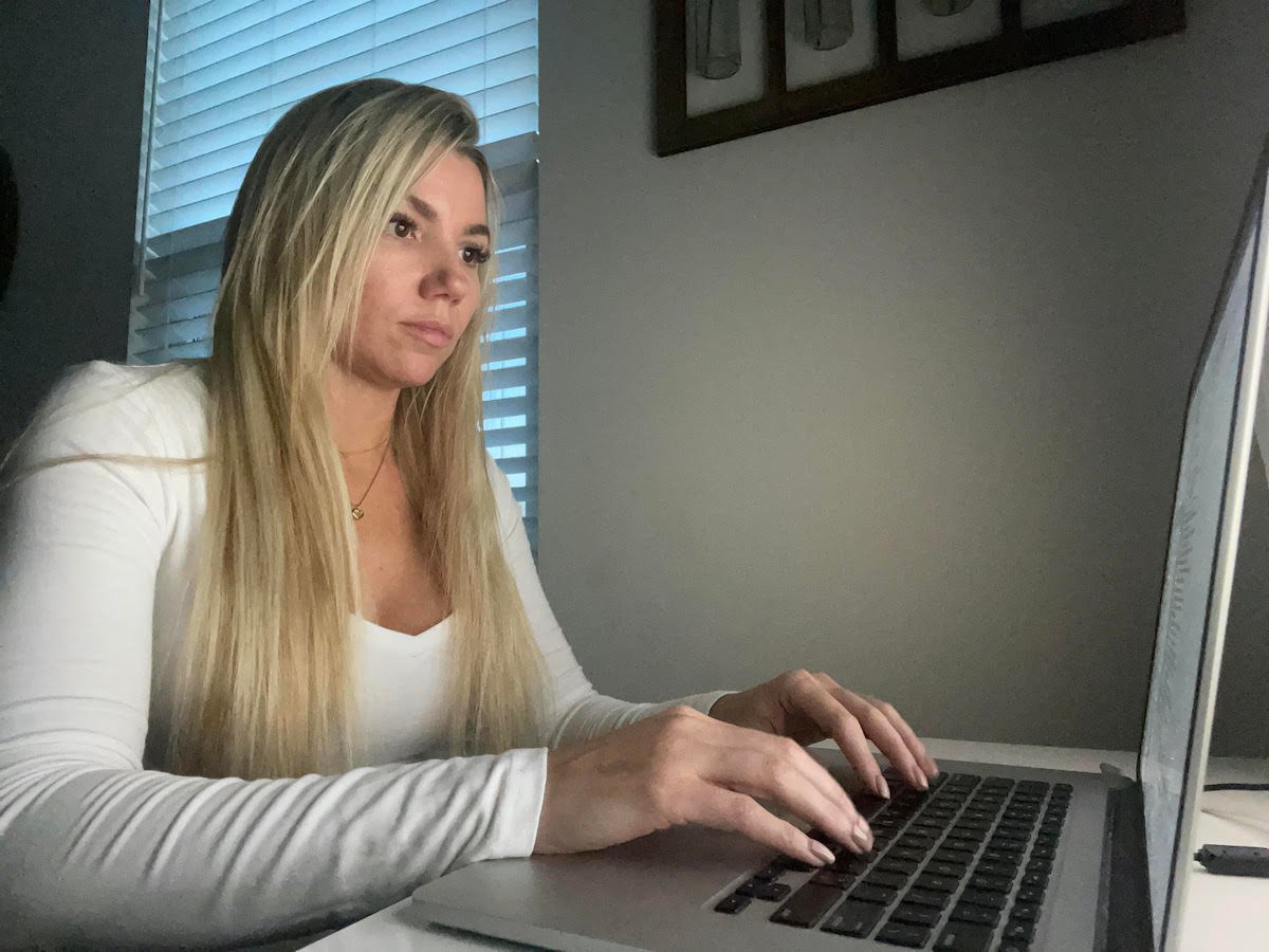 Bridget Barrett, a member of our client outreach team sits in her home office in front of her laptop.