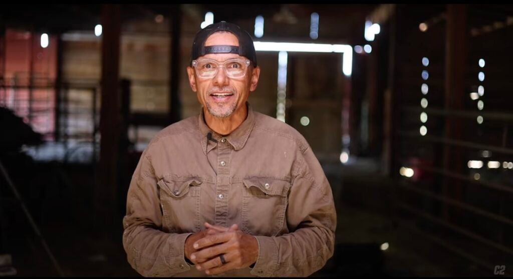 Screenshot of Roseville, California-based photographer Carl Costas in a light brown button down shirt and black baseball cap, styled backwards.