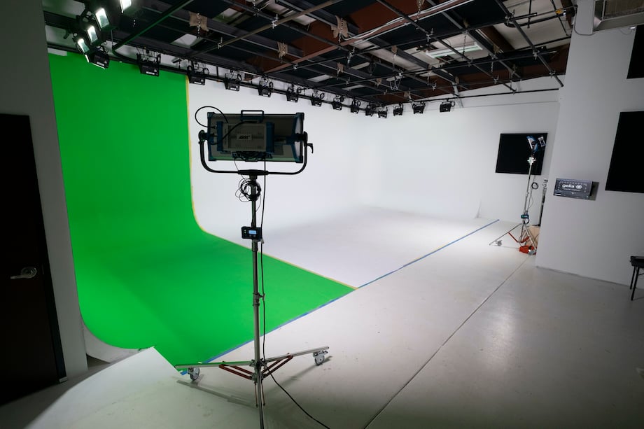 View of a green screen and cyclorama with lighting permanently rigged and controlled using a touchscreen system.