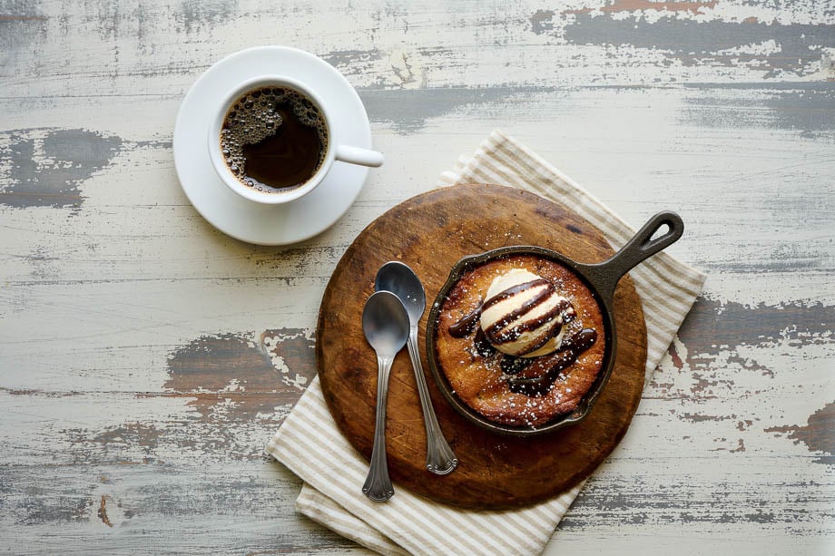 Bird's eye view photo of a cup of coffee and baked pie with ice cream on top taken by Boston-based food photographer Douglas Levy. 