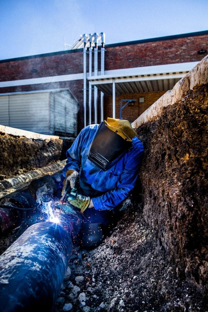 Photography of a worker tinkering by Minneapolis Industrial photographer Drew Anthony Smith.
