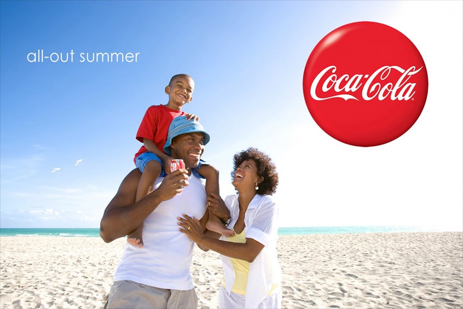 A happy family on a beach in Robert Holland's charming lifestyle photography for Coke