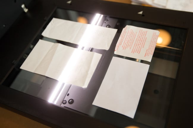 an image of receipts face-down on a scanner to be copied
