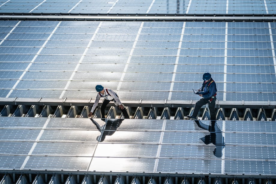 Photo of two men on top of some solar panels taken by Atlanta-based industrial photographer Gary S. Chapman. 