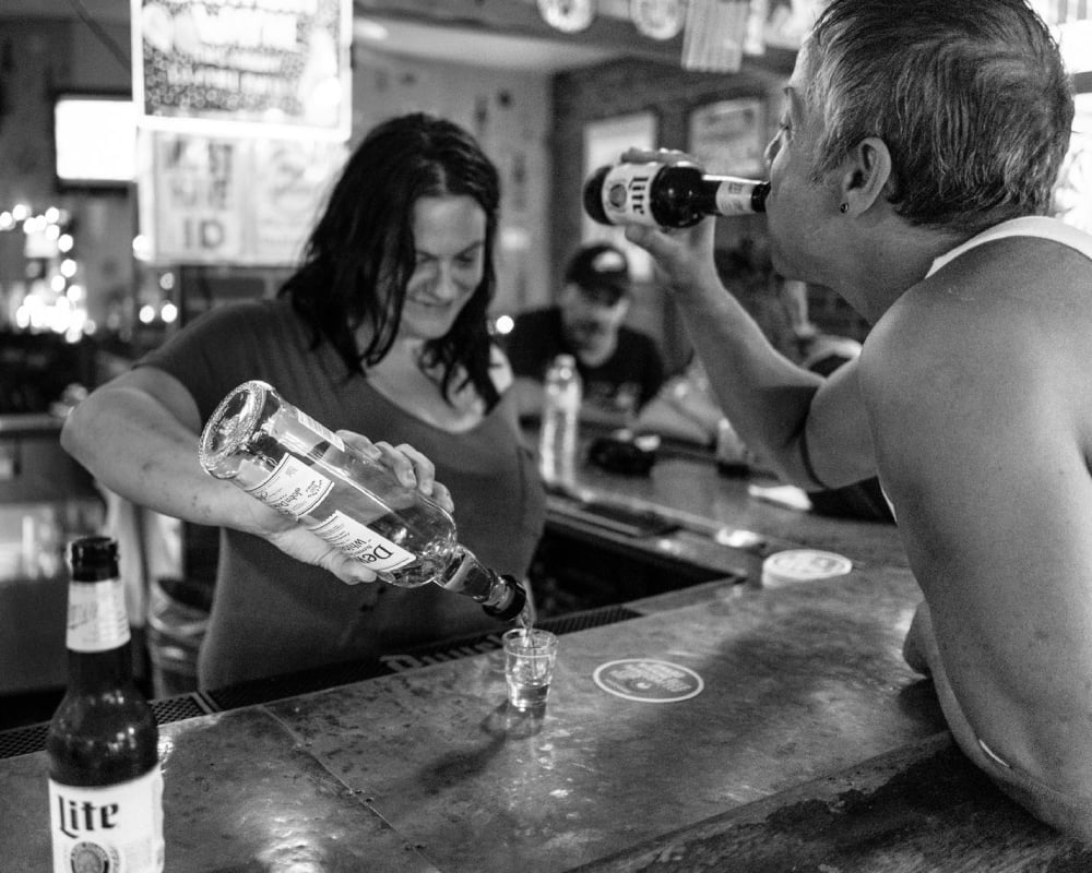 Photo by Gene Smirnov of a bartender pouring a drink.