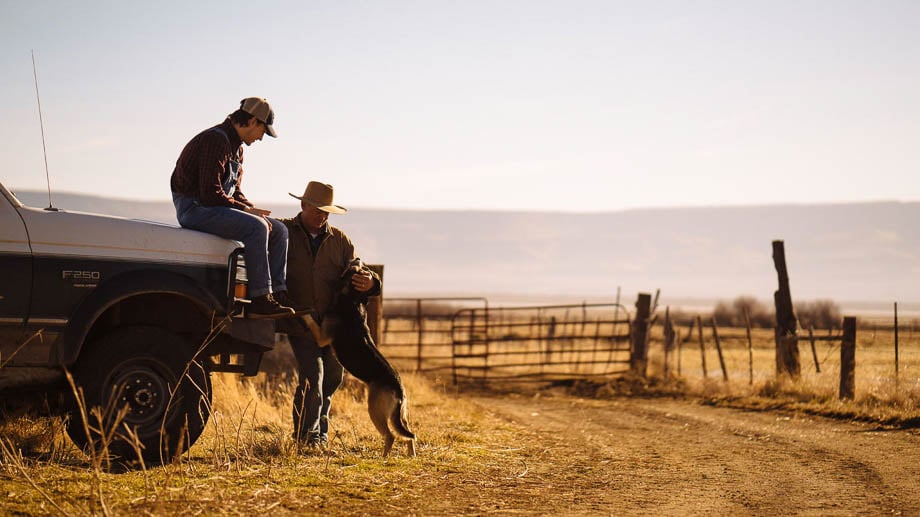 Photo of a father and son with their dog at an American ranch taken by Philadelphia-based lifestyle photographer Gene Smirnov. 