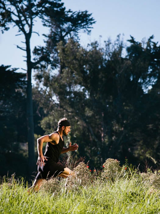 Photo of a man going for a run outdoors taken by San Francisco-based fitness photographer Ian Tuttle. 