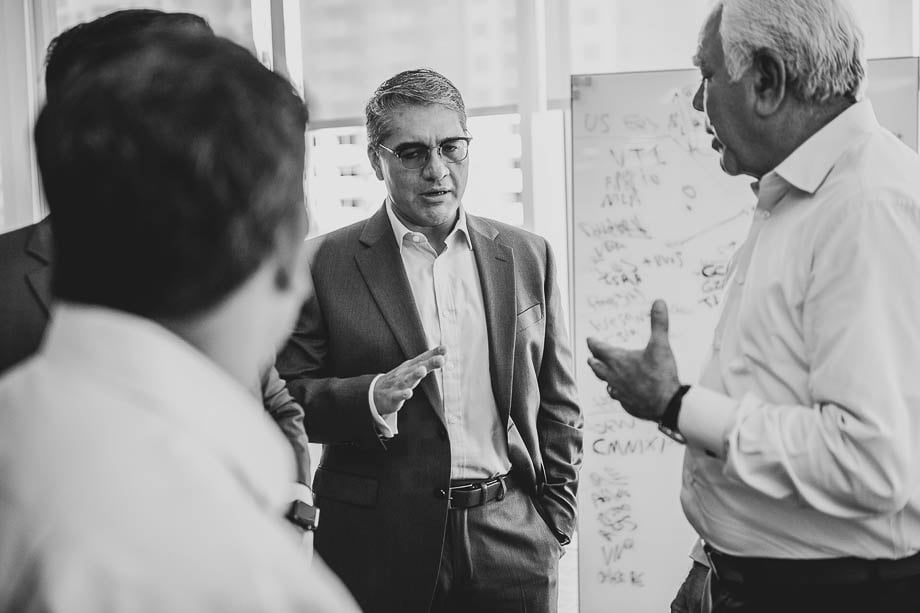 Black and white photo of businesspeople having a discussion taken by Miami-based corporate photographer Jason Nuttle. 