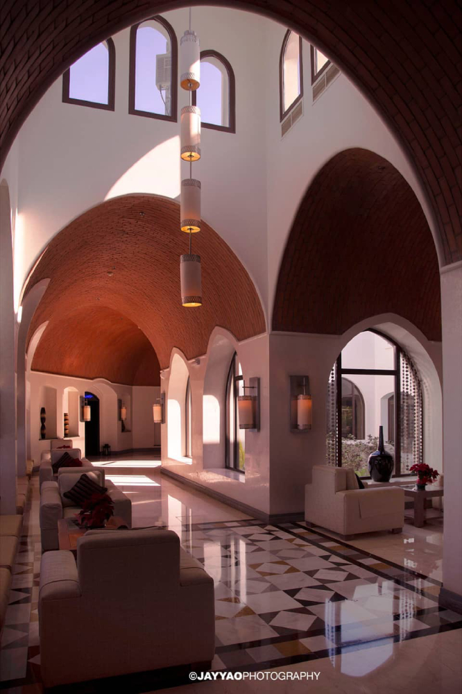 An interior color photograph by Jay Yao depicting the archways in an Arabic hotel.