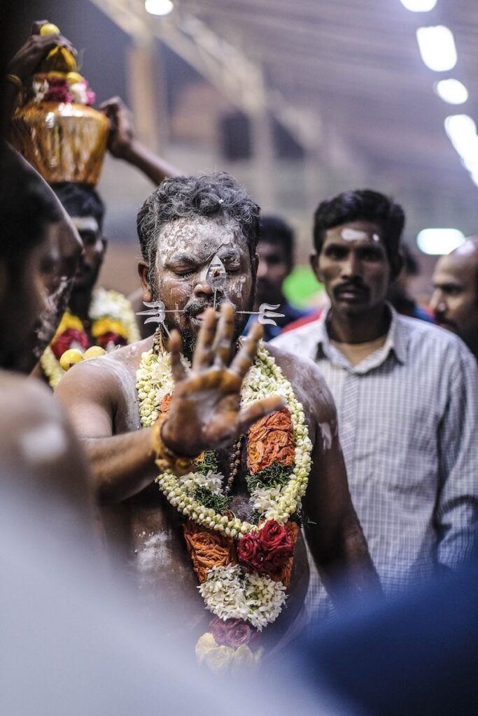 Photo depicting a man during Thaipusam, a major Hindu religious festival that lasts for 2 days, shot by José Jeuland.