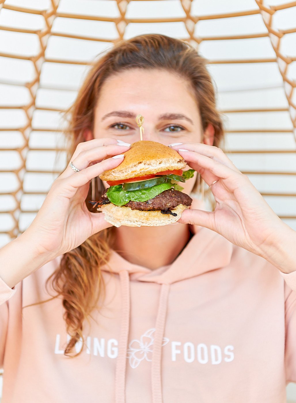 girl eating burger at living foods shot by joseph weaver