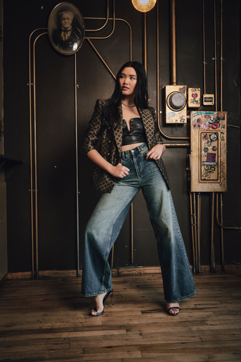 A stylish woman effortlessly exhibits her casual-chic ensemble amidst industrial surroundings, seamlessly blending urban and fashion aesthetics, photo by Atlanta fashion photographer Lindsey Dowell.