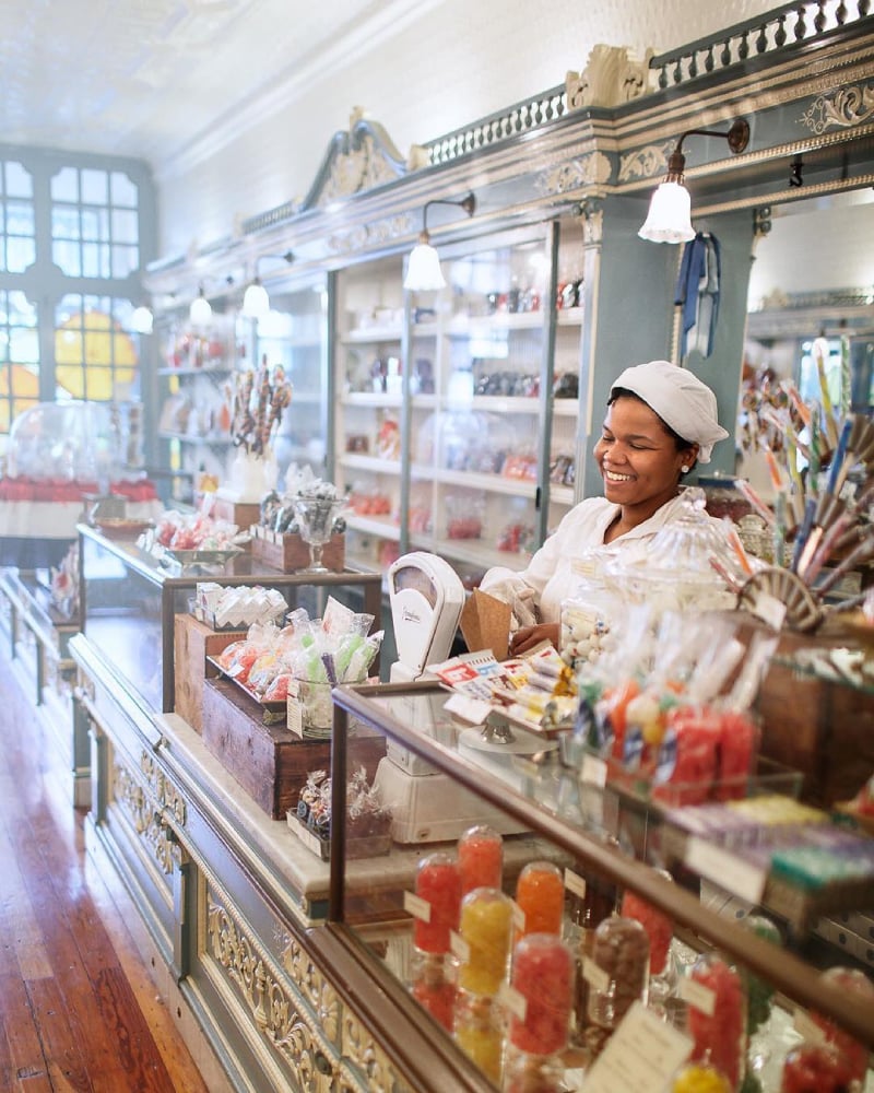 Photo by Matt Stanley of a woman working in an old-fashioned candy shop.